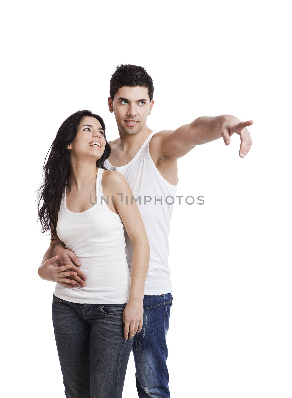 Beautiful and happy young couple standing over a white background