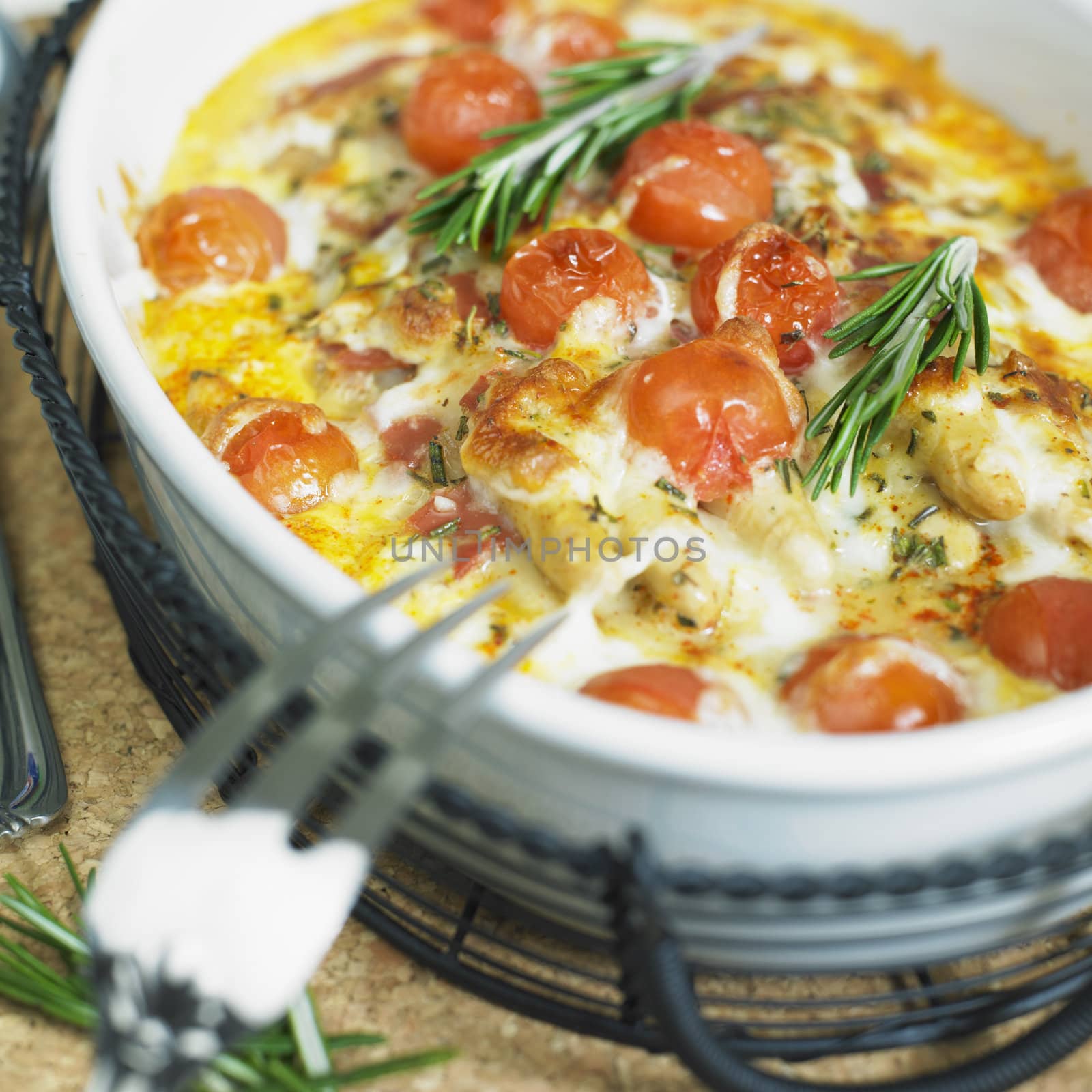 baked white asparagus with cherry tomatoes on rosemary