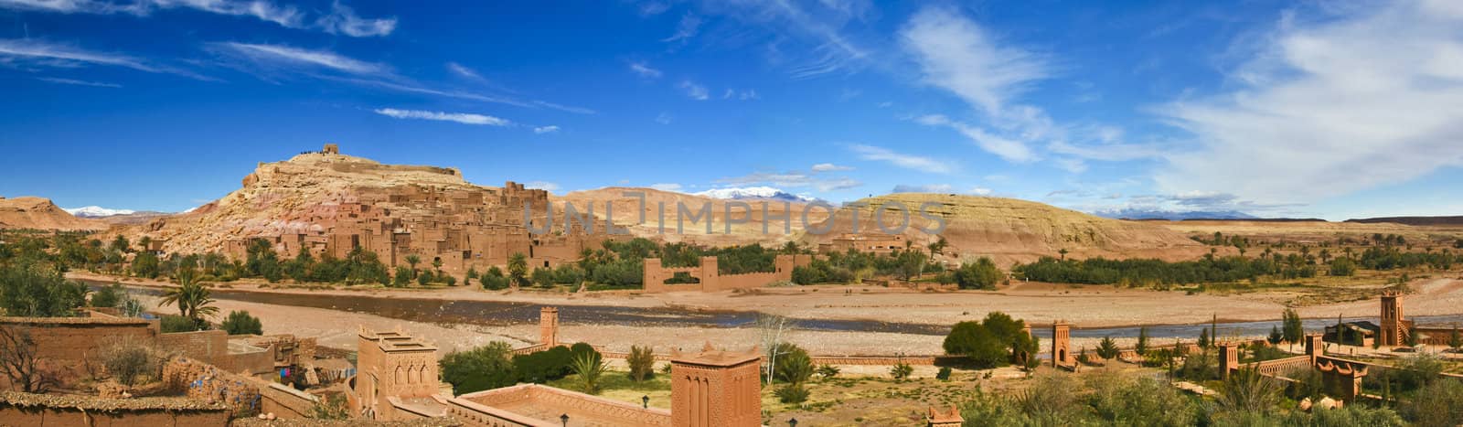 Panorama of the ancient moroccan kasbah Ait Benhaddou, near Ouarzazate - Unesco world heritage. Snow covered Atlas mountains can be seen in the background.