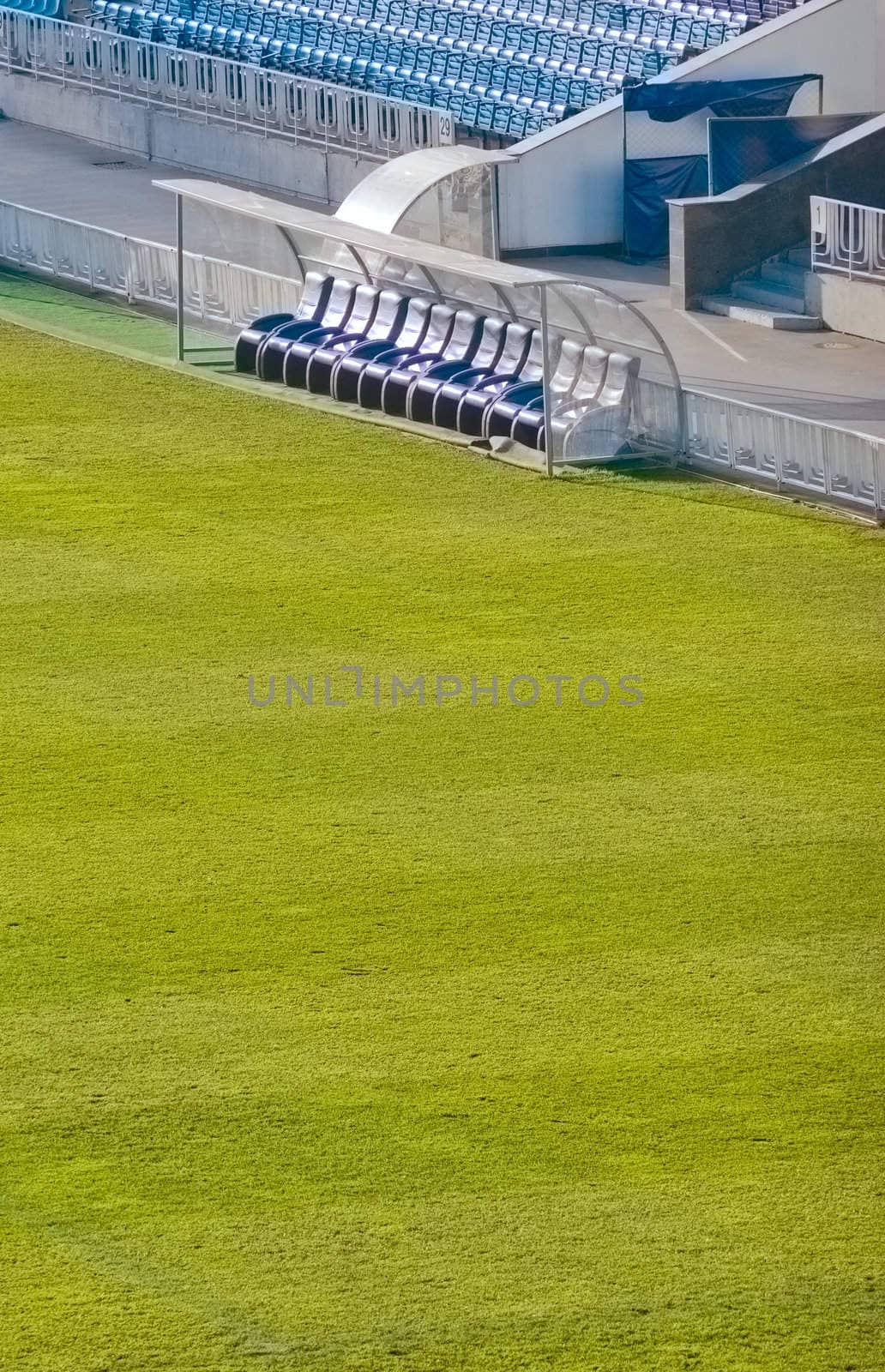 Benchwarmers on an empty soccer field