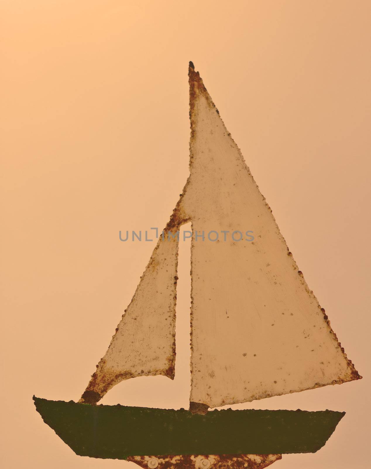 An old, rusty, retro, vintage, sailing boat sign.