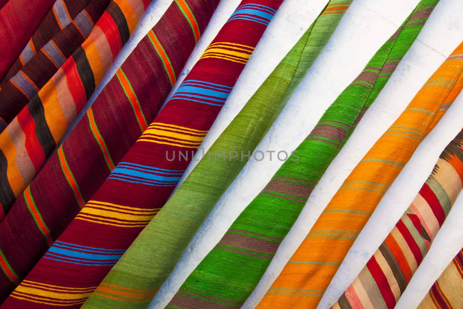 Colourful  carpets sold in maroccan souk.