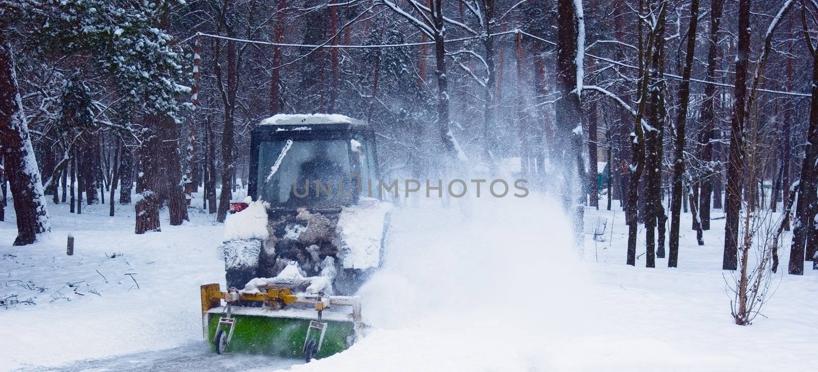 Tractor cleaning snow in winter Park