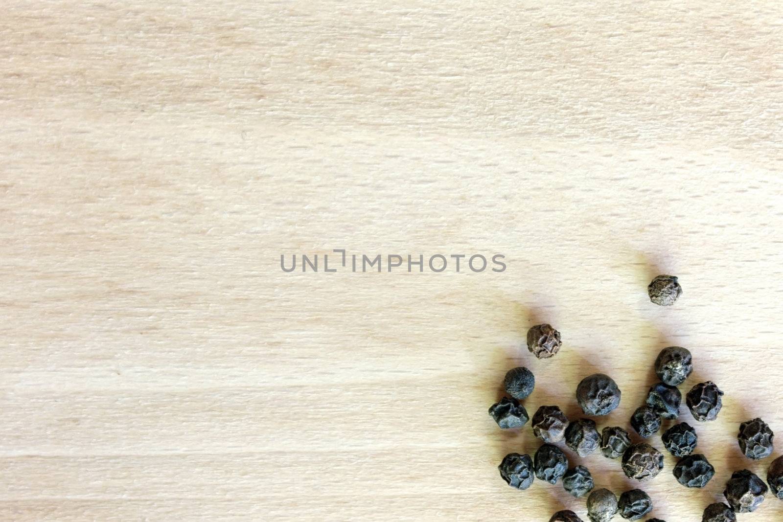 Black Pepper grains in the bottom right corner of the chopping board