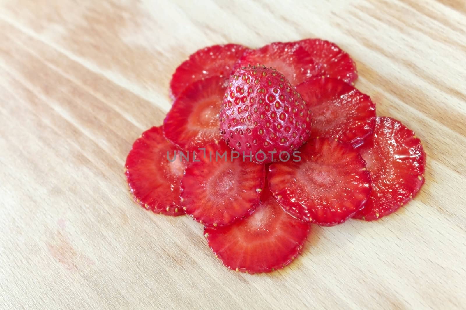 strawberries slices composed as flower on the cutting board