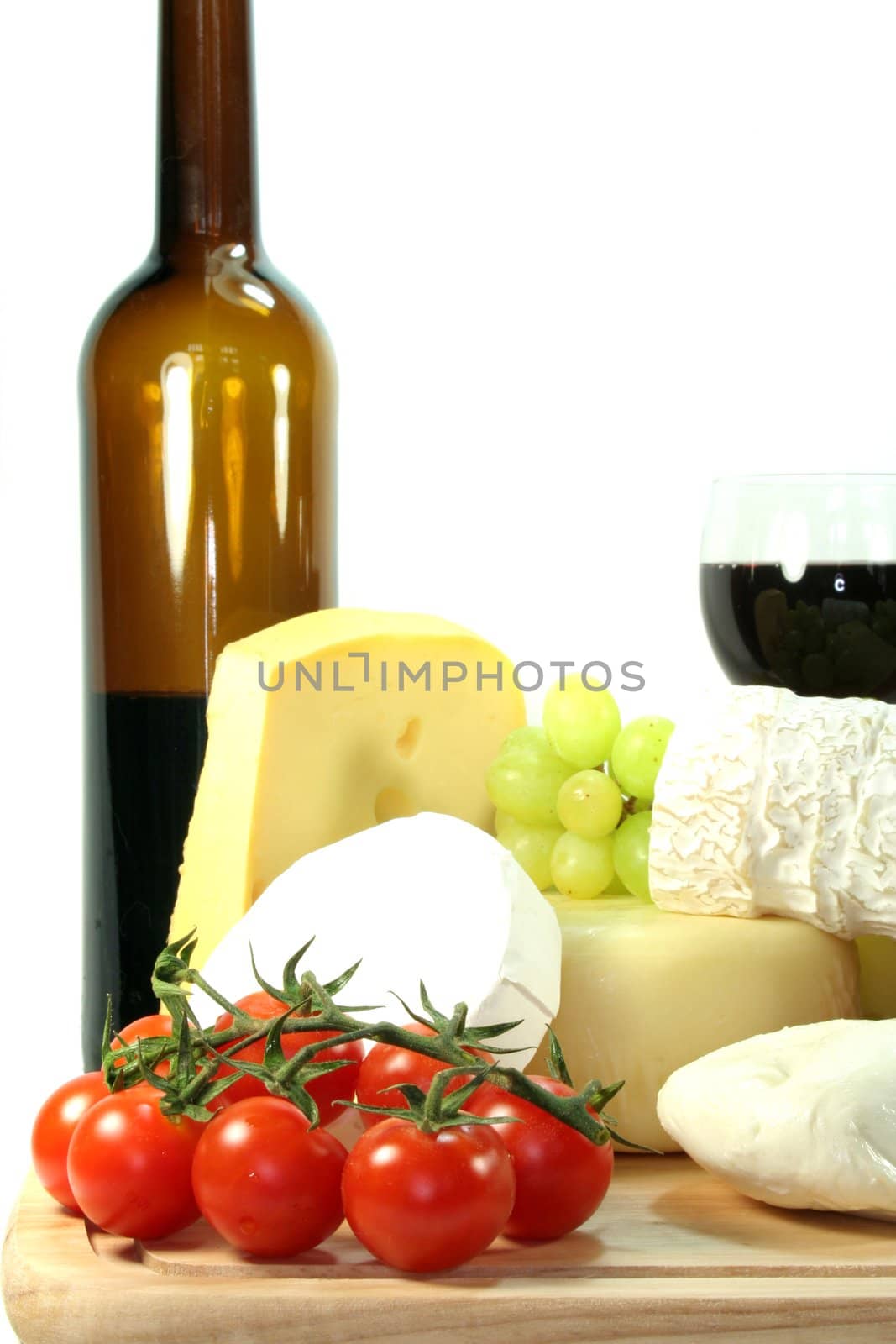 Cheese with fresh grapes, tomatoes and red wine