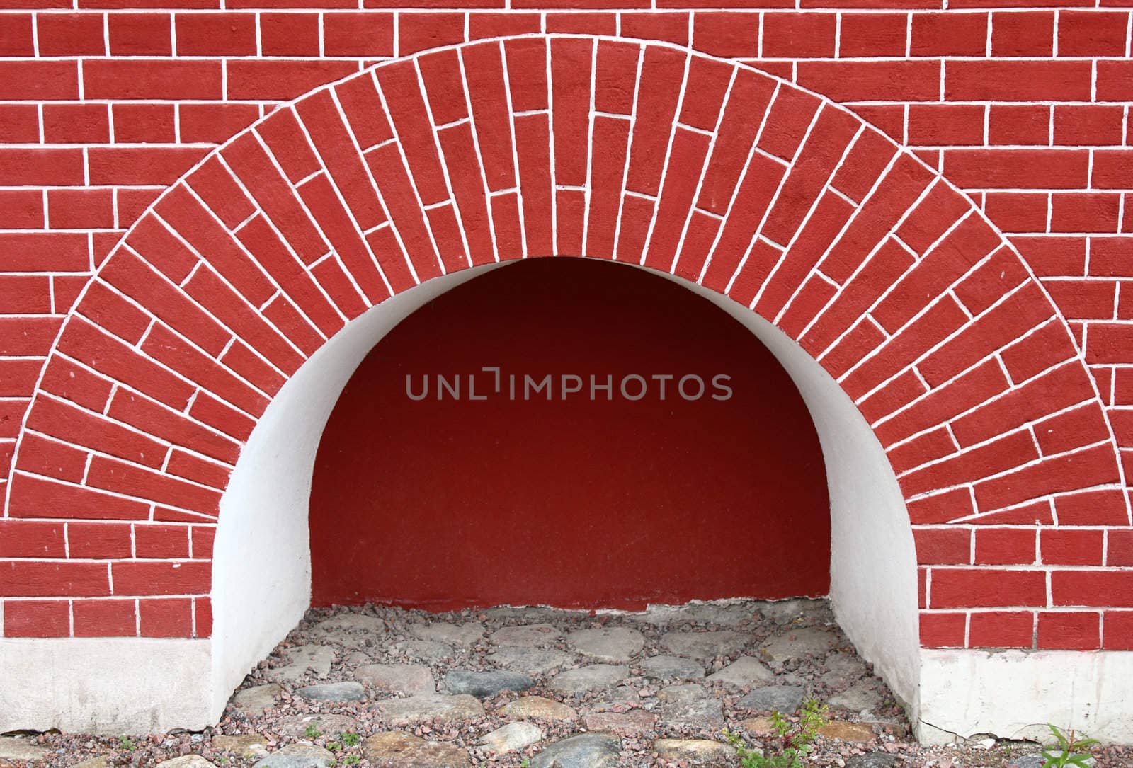 Niche in red brick wall with brick arch