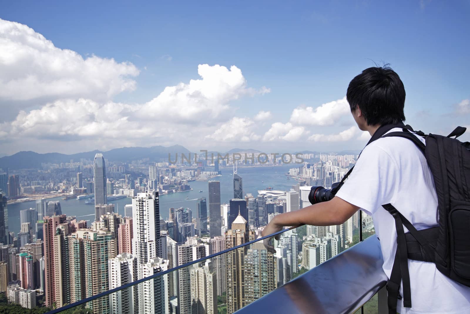 Tourist taking photo of Hong Kong skyline by his digital camera 