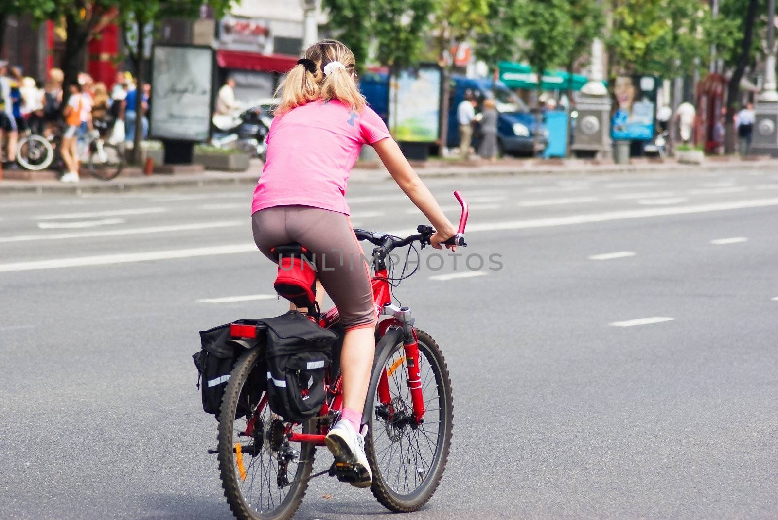 A person riding a bicycle on a empty street