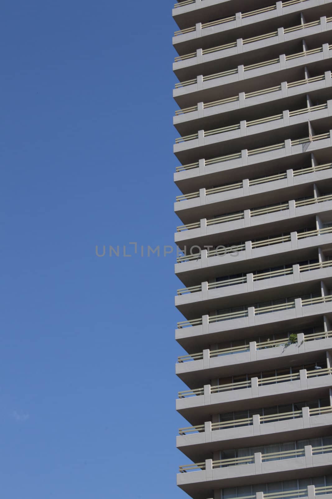 Side of a building sky scraper with blue skies in the background by jeremywhat