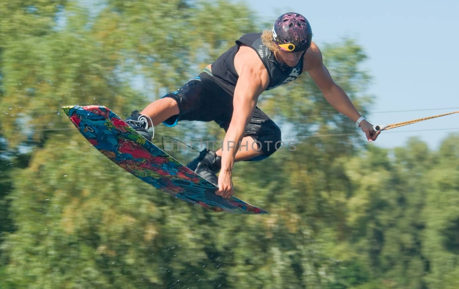 Young man wakeboarding on the lake 