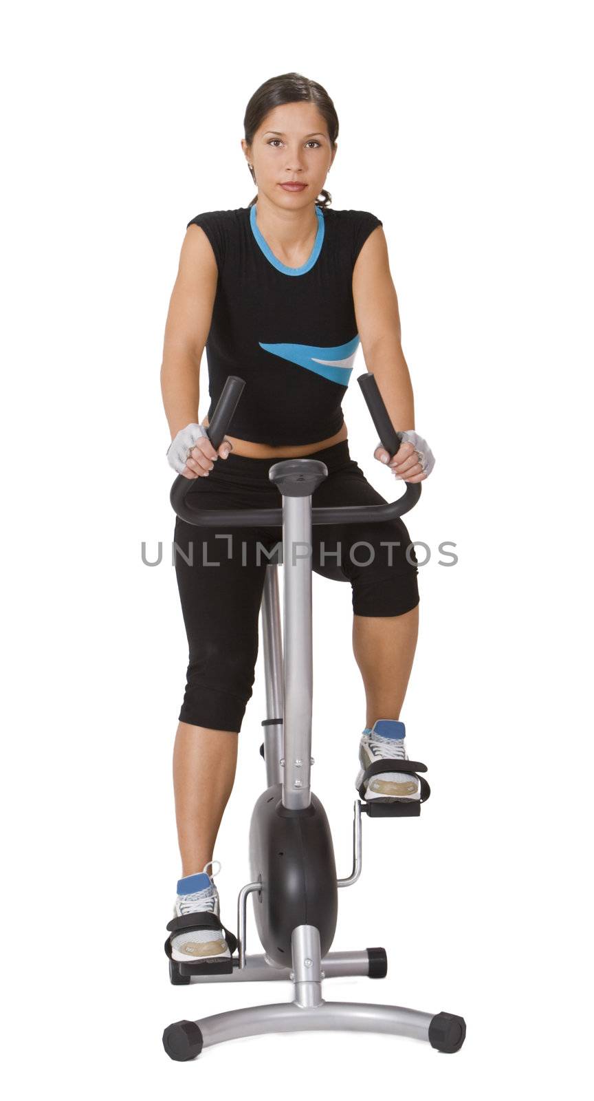 Young woman riding a fitness bicycle isolated against a white background.