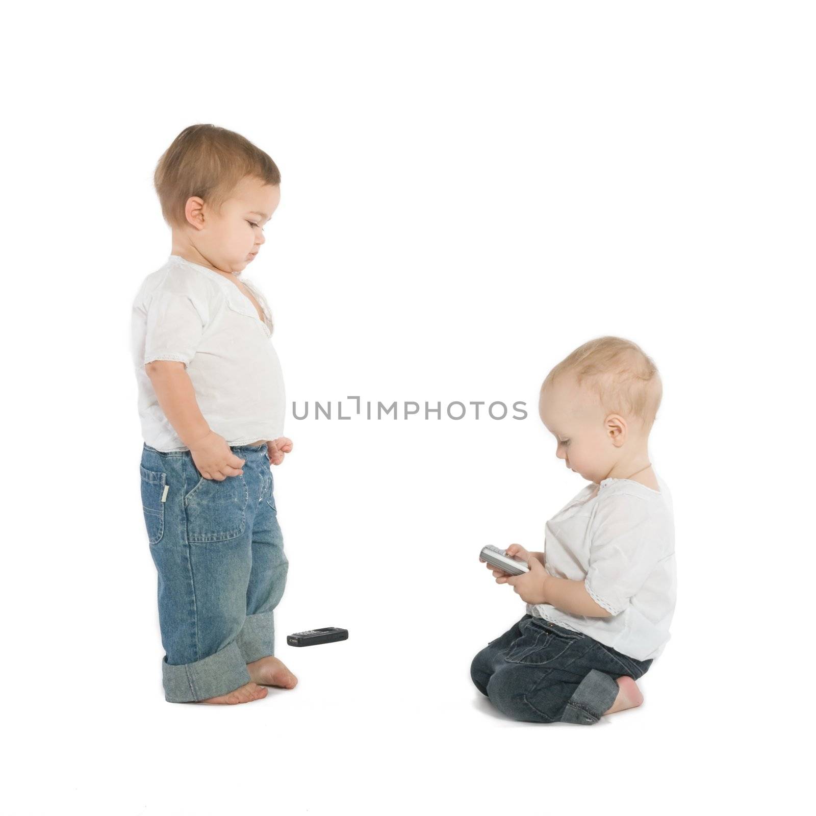Two little boys with cellphones, white background
