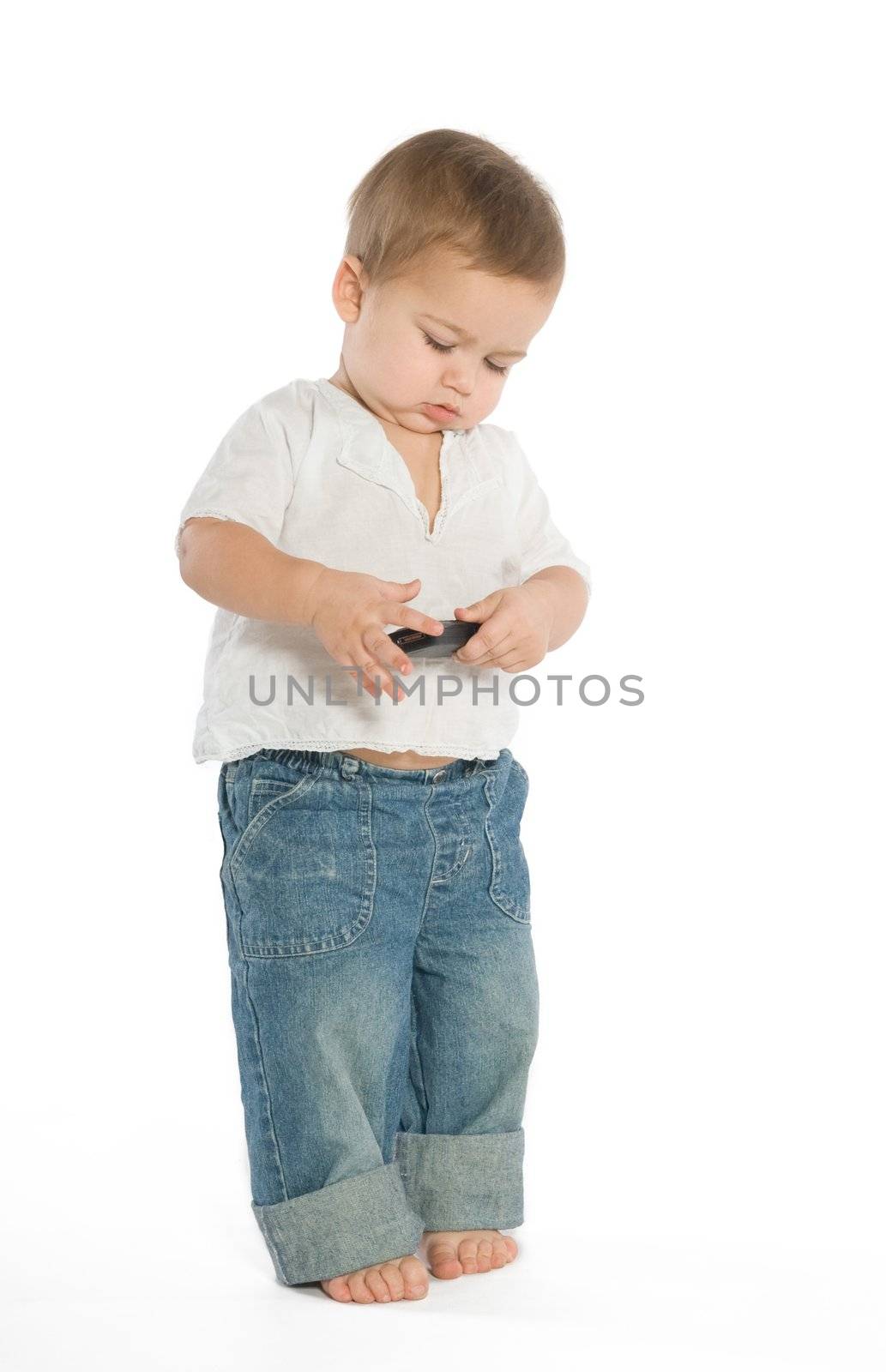 A little boy experimenting with a cellphone
