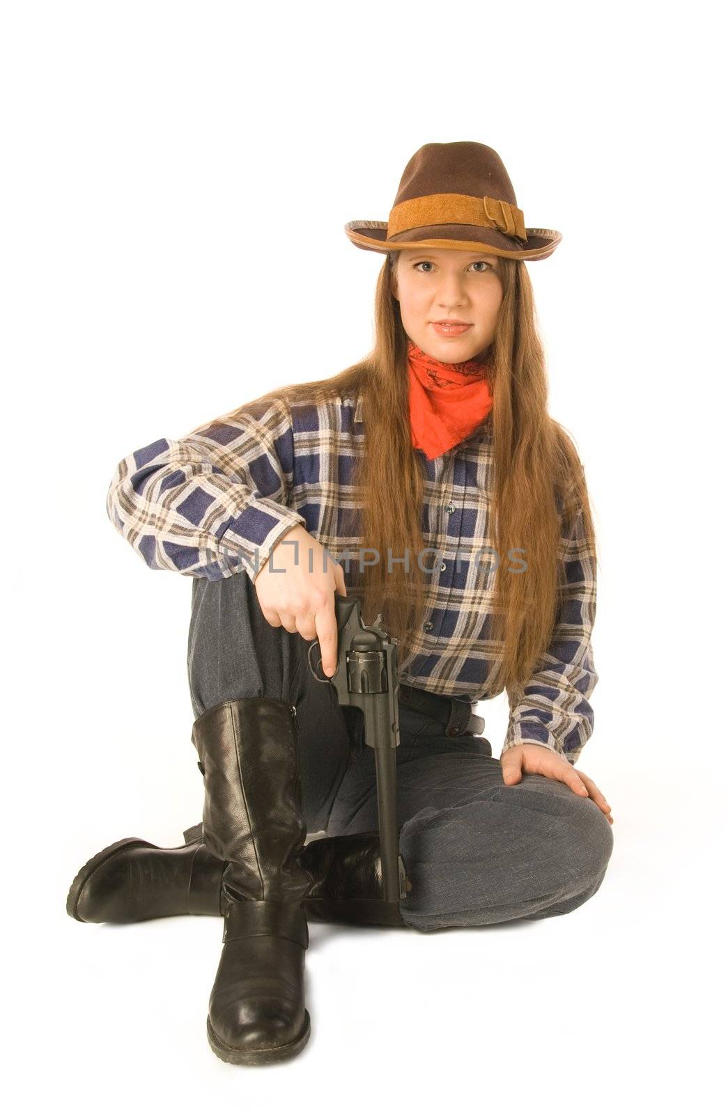 Young woman wearing cowboy clothes holding a gun