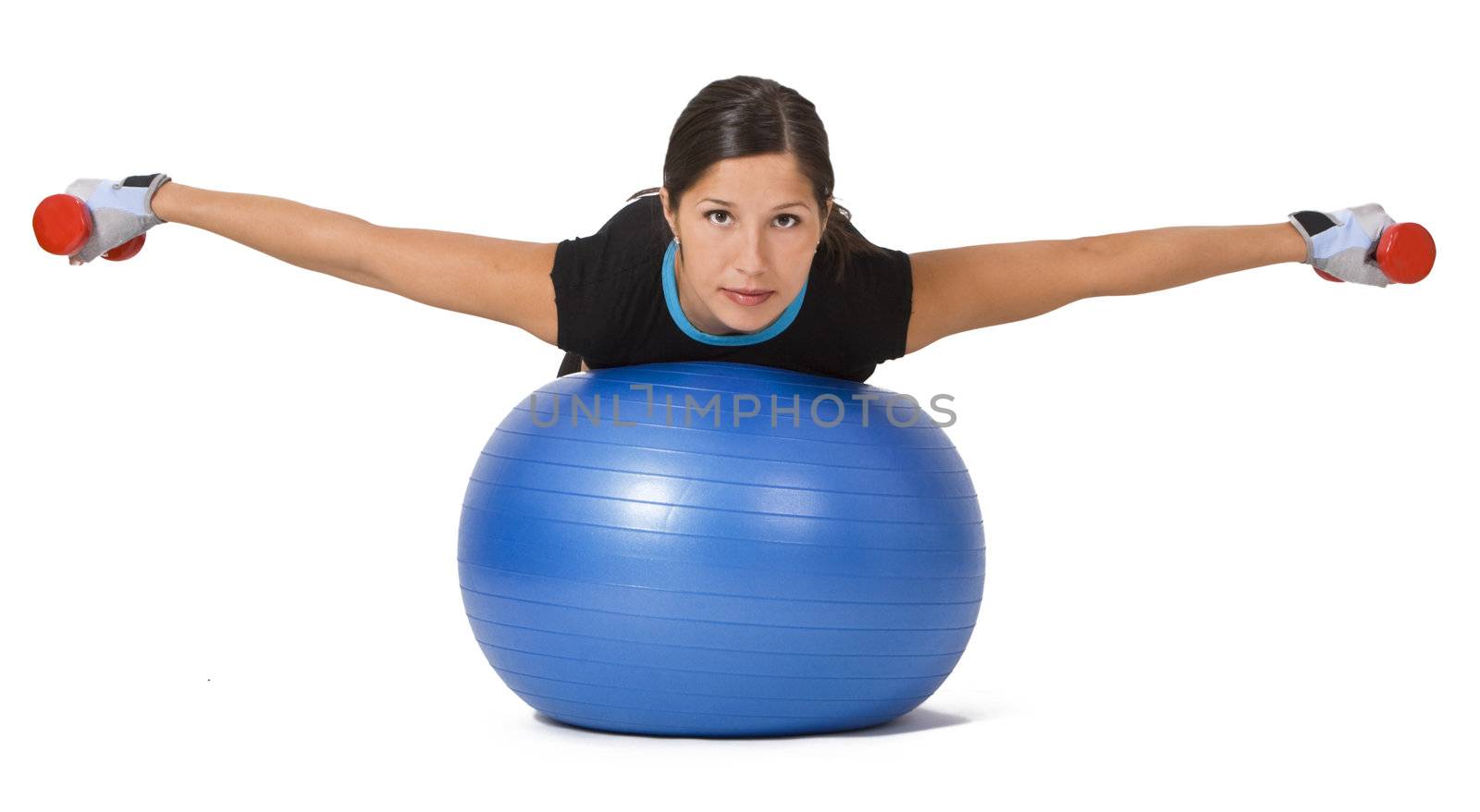 Young woman doing an exercise with barbells and a fitness ball