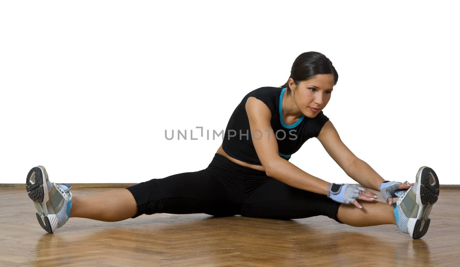 Active young woman doing warming up stretching movements.