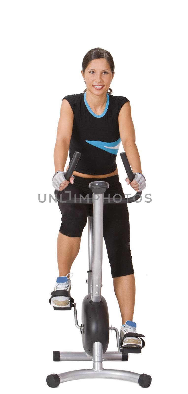 Smiling young woman riding a fitness bicycle isolated against a white background.
