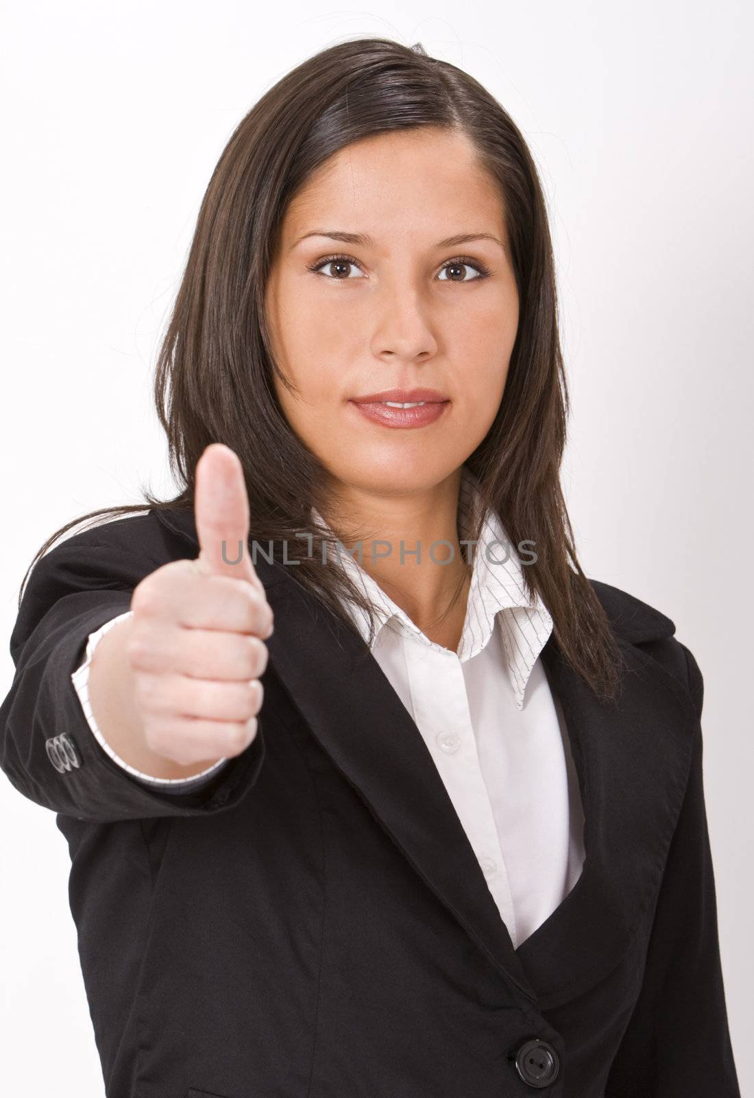 Businesswoman making a characteristic thumb-up gesture - selective focus on the face.
