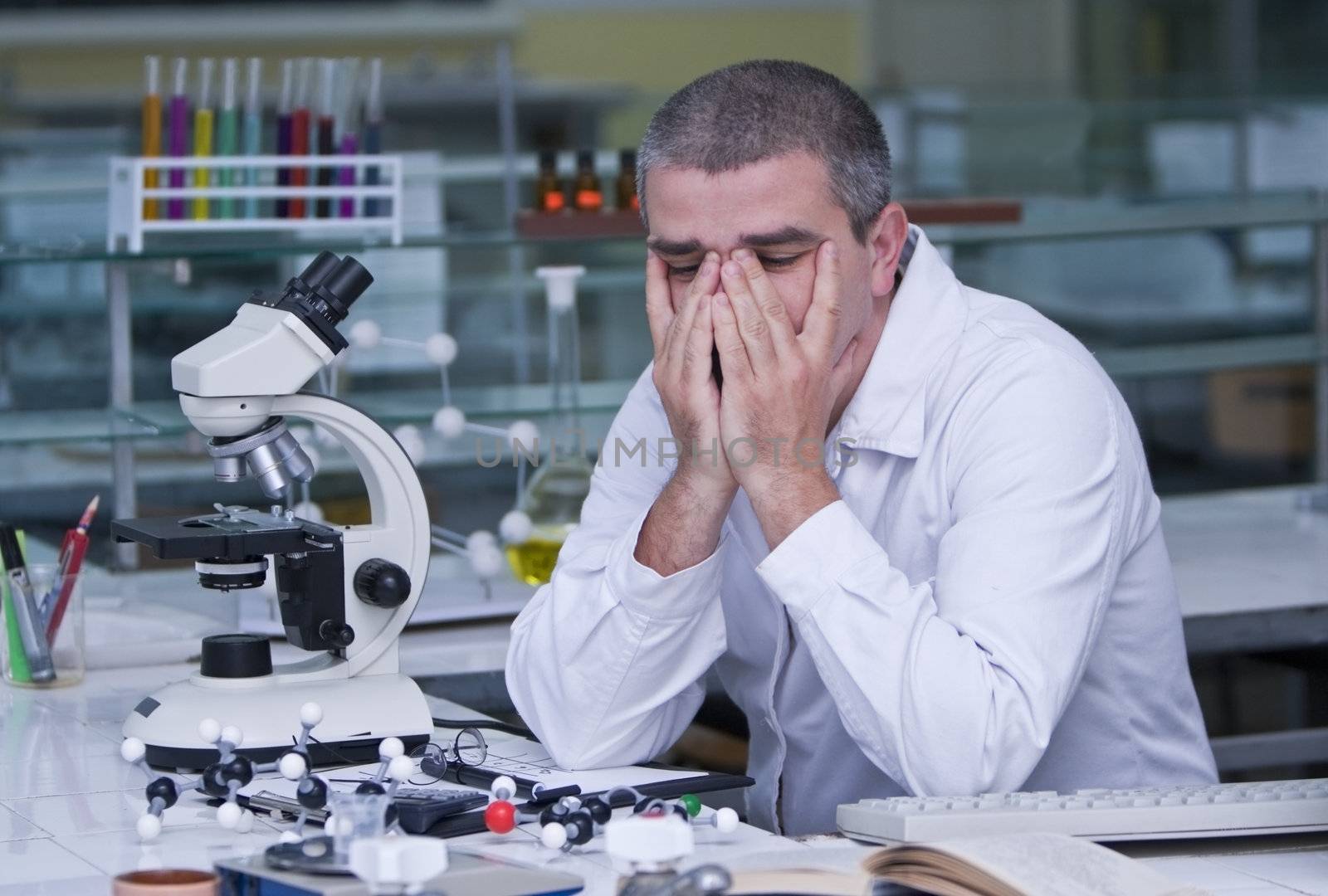 Tired researcher at his workplace.