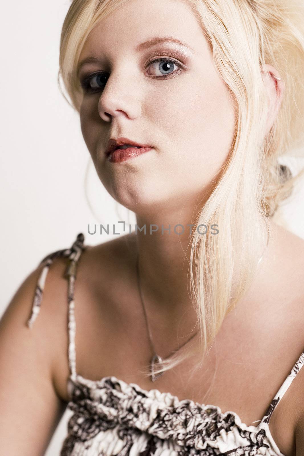 Studio portrait of a blond young lady with an attitude