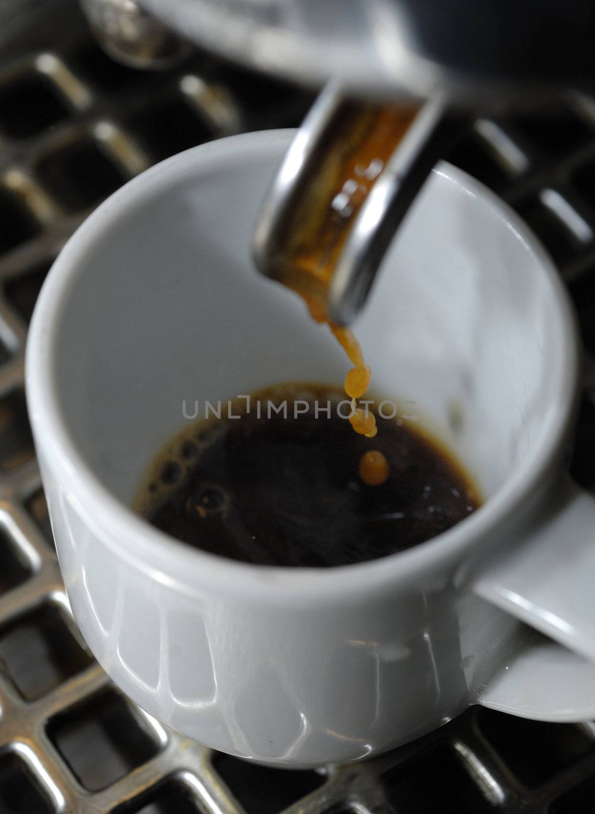 machine filling a white porcelain cup, Milan,Itay