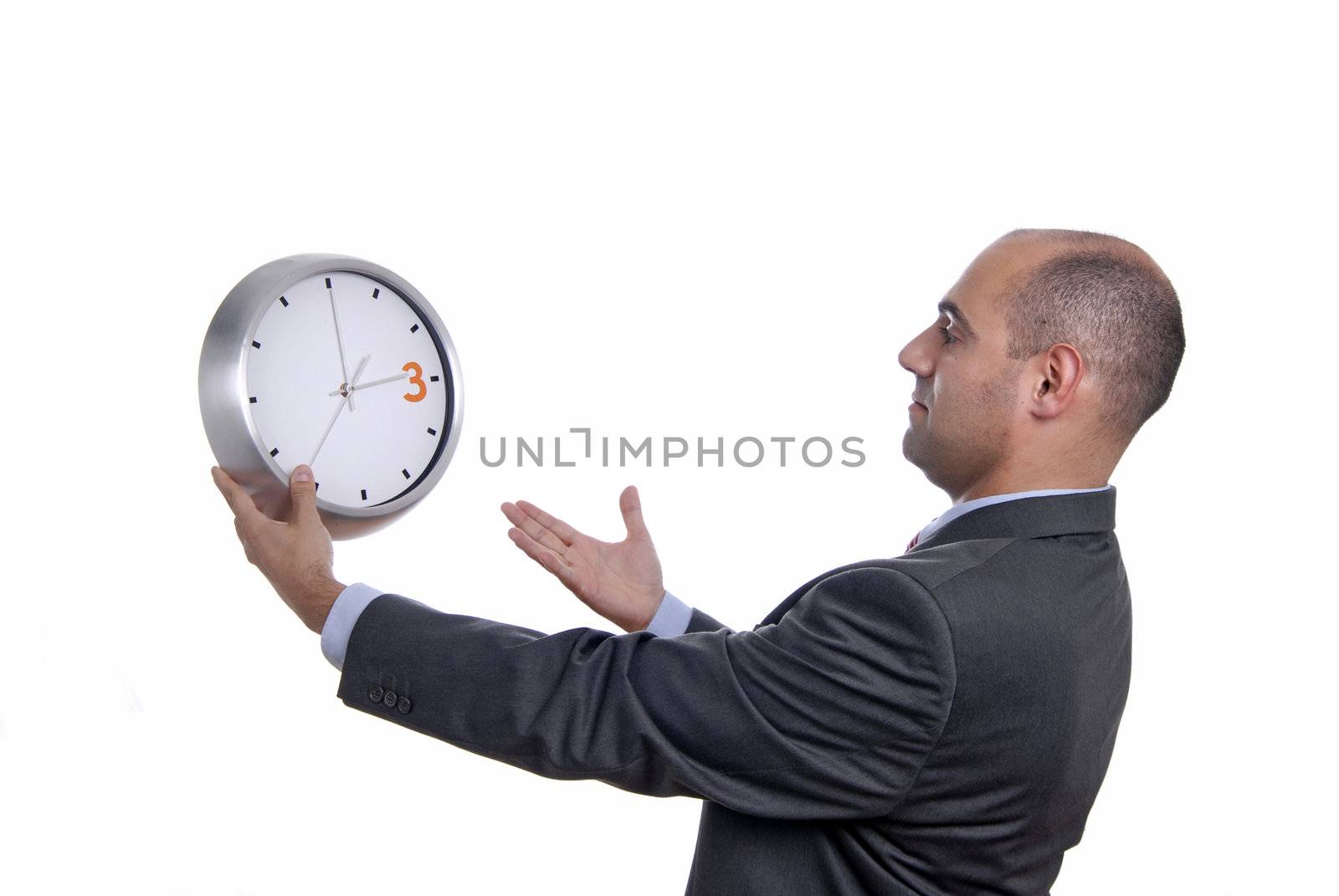 A handsome business man holding a clock