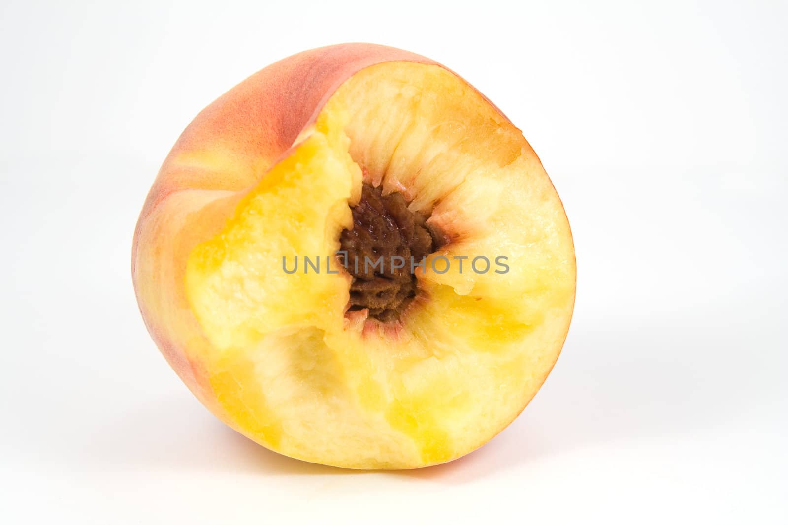 Bitten juicy peach on white by serpl