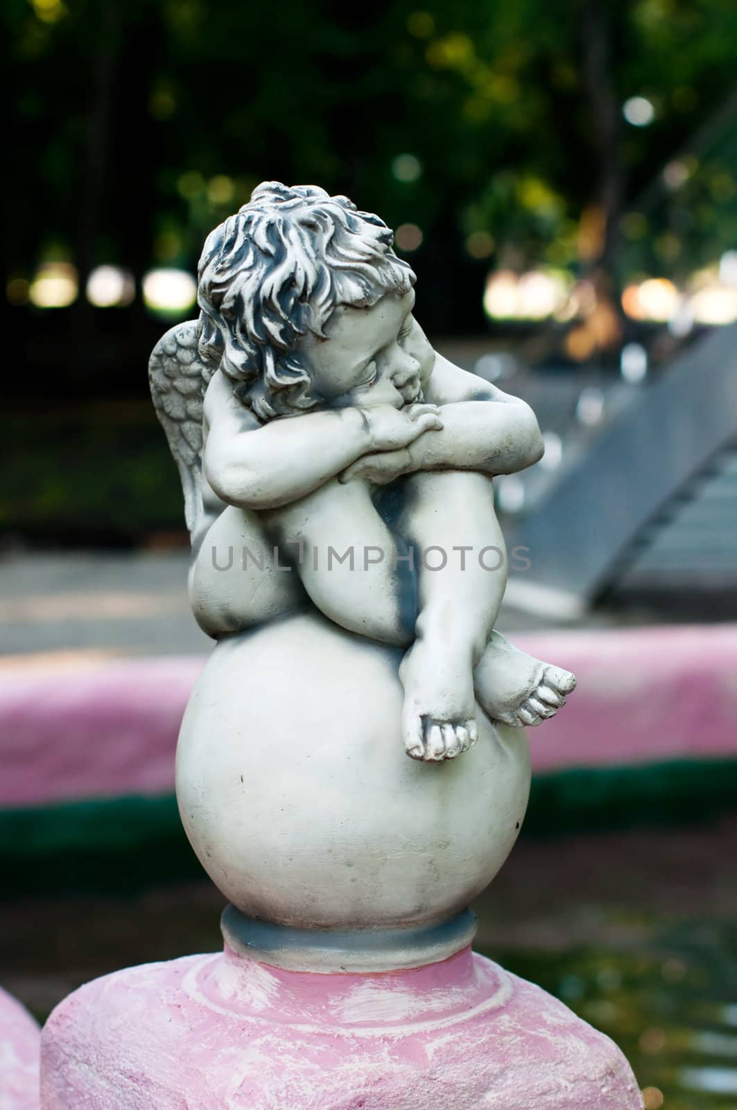 An angel statue sitting on a fountain