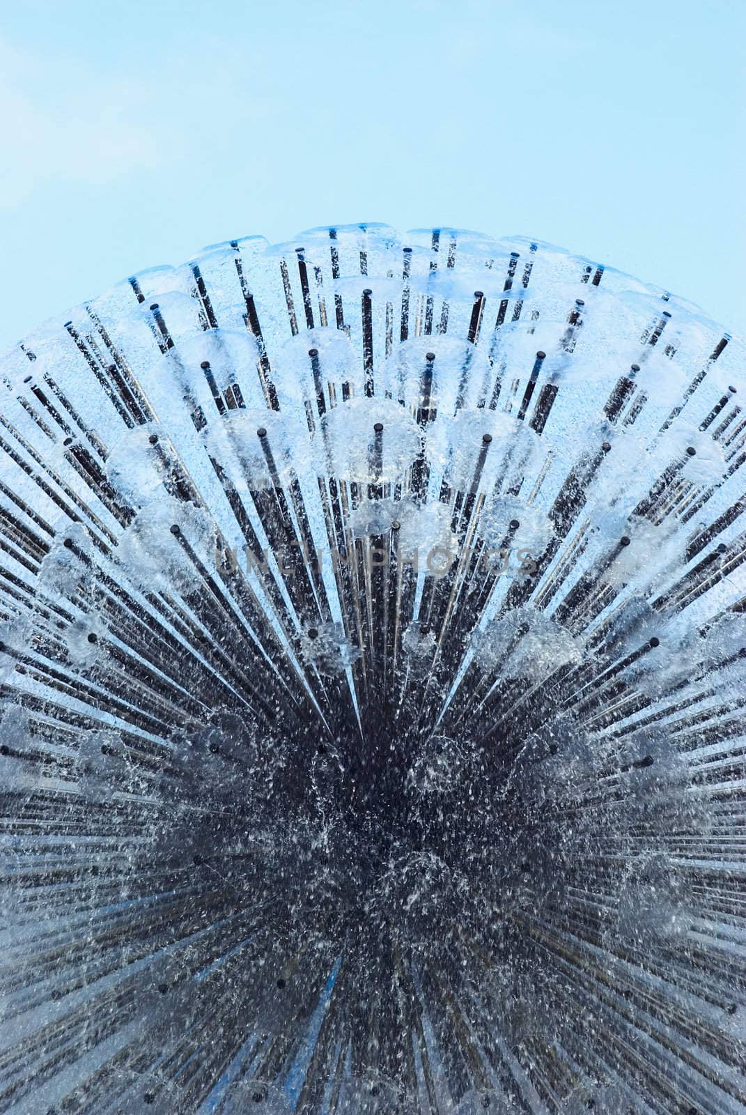 
splashing fountain in the background of blue sky