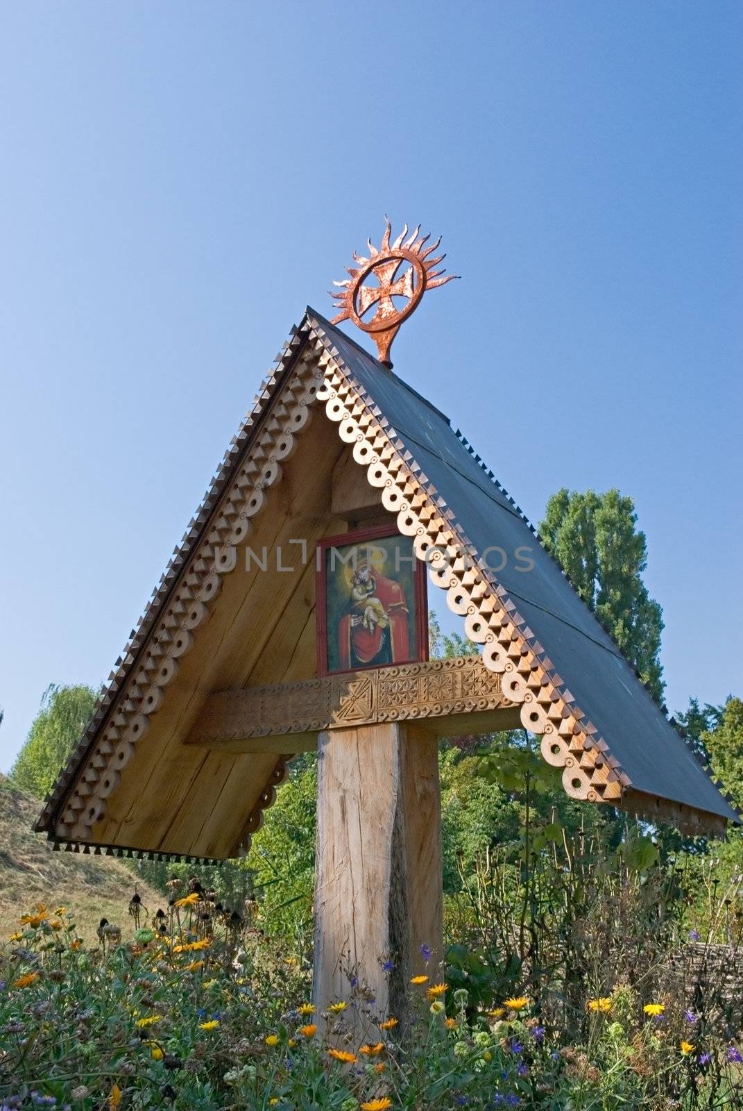 old wooden cross standing on a meadow