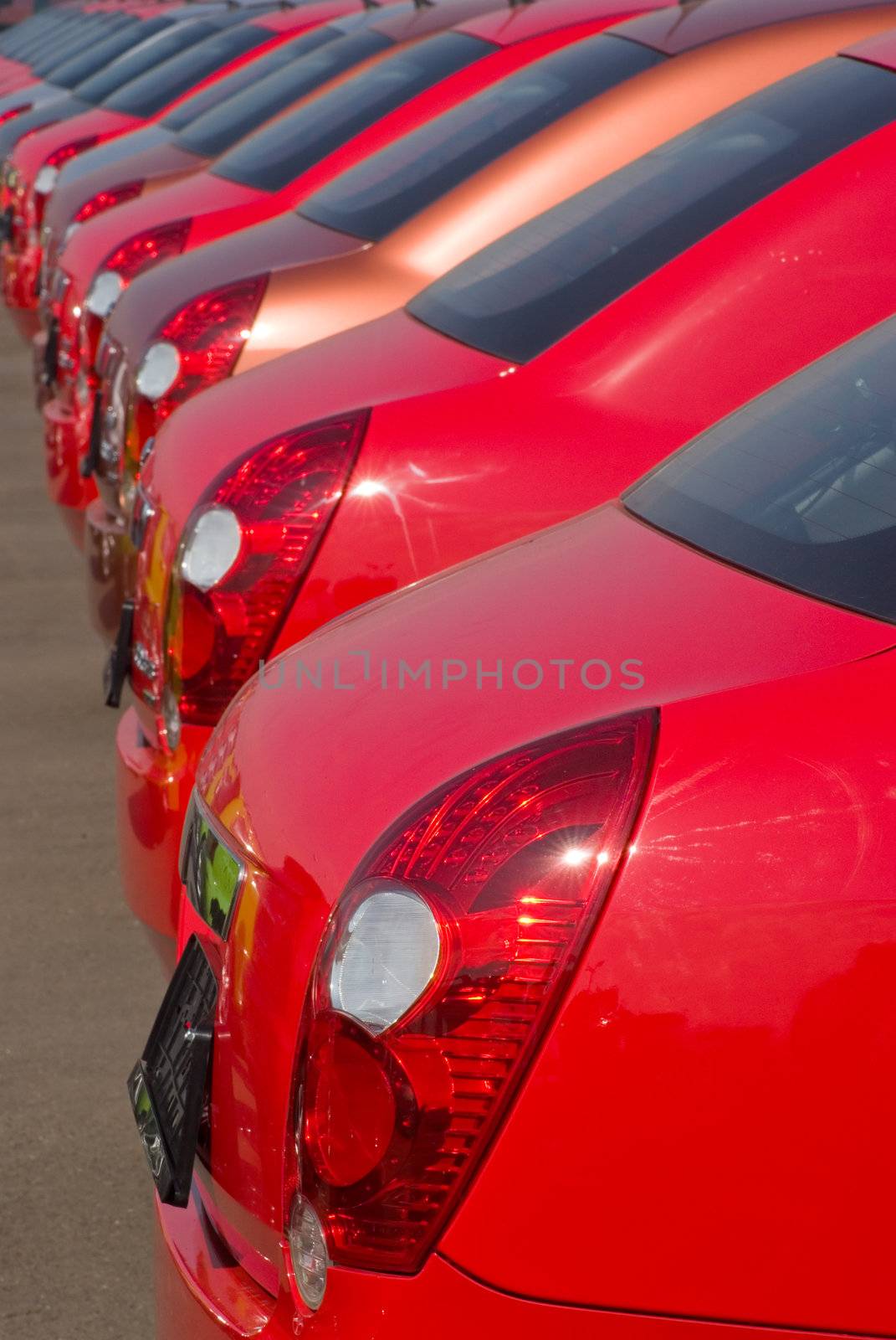 A row of new cars parked at a car dealer shop 