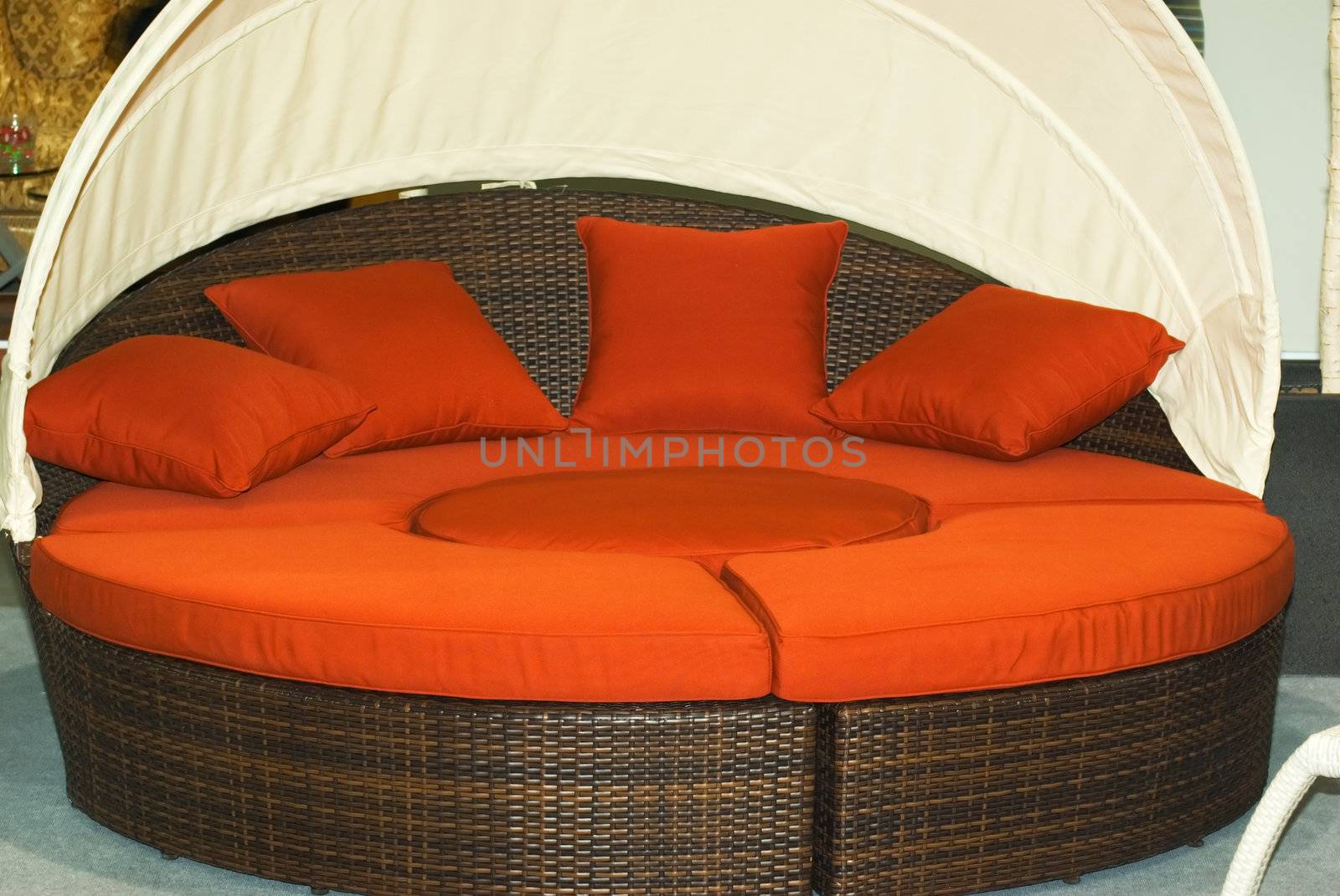 Round woven sofa with a canopy