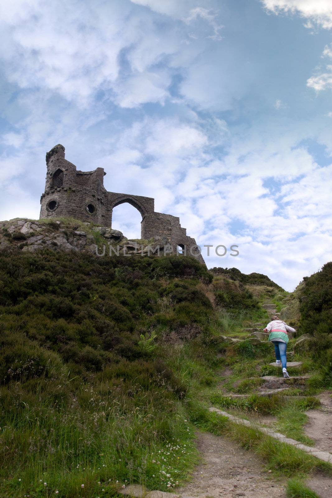 a young girl climbing to mow cop castle in the Biddulph valley in the county of Staffordshire in England