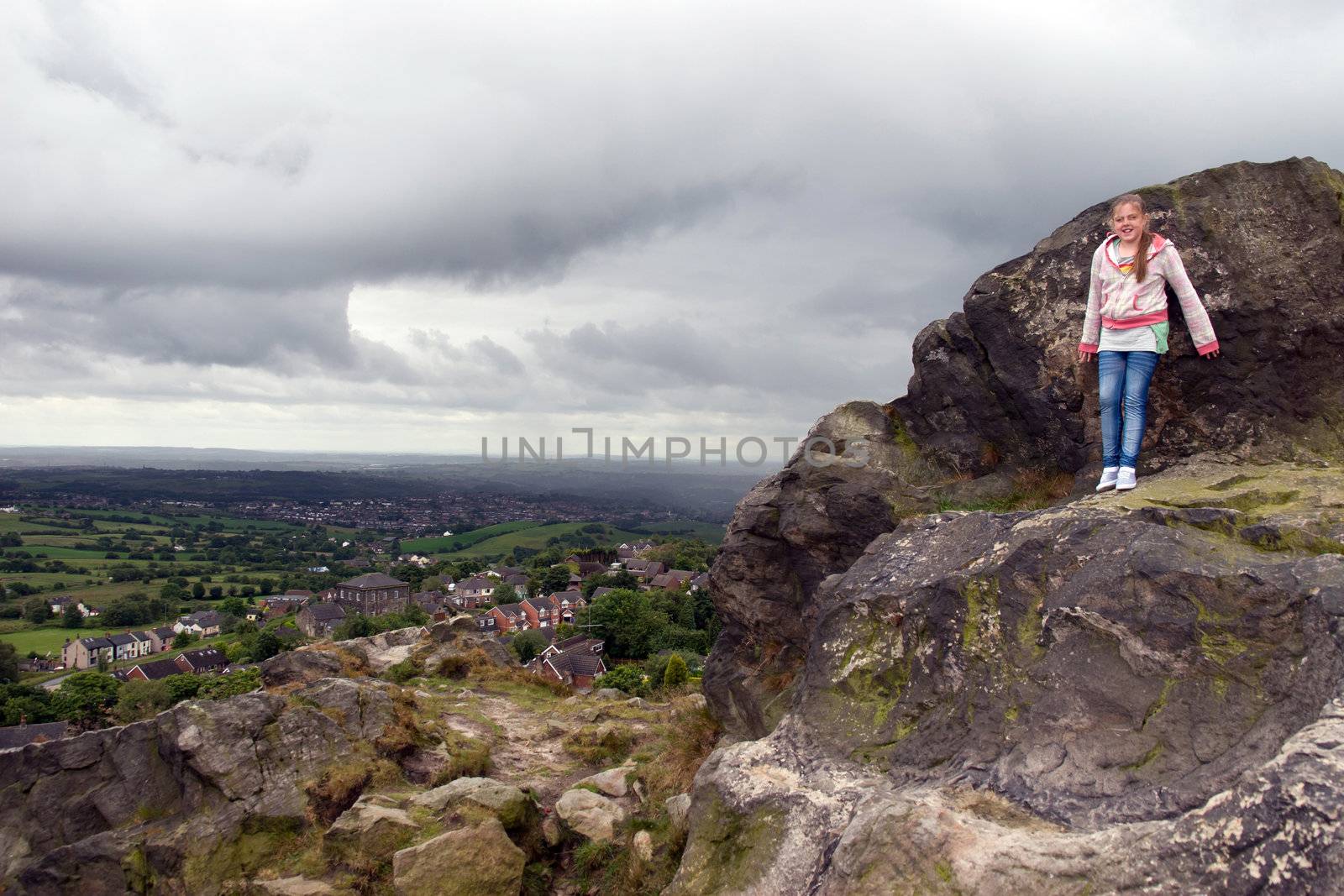 girl on cliff with view of English cheshire countryside by morrbyte