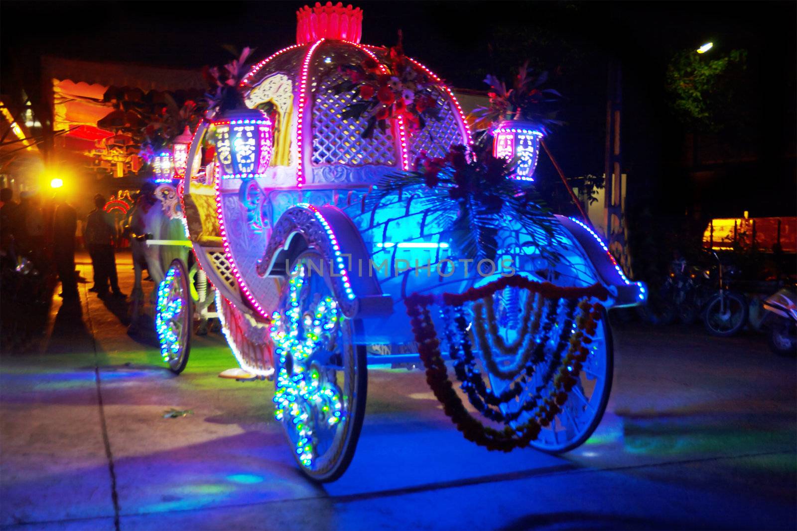 Indian wedding grooms carriage brightly lit up at night in Indian village
