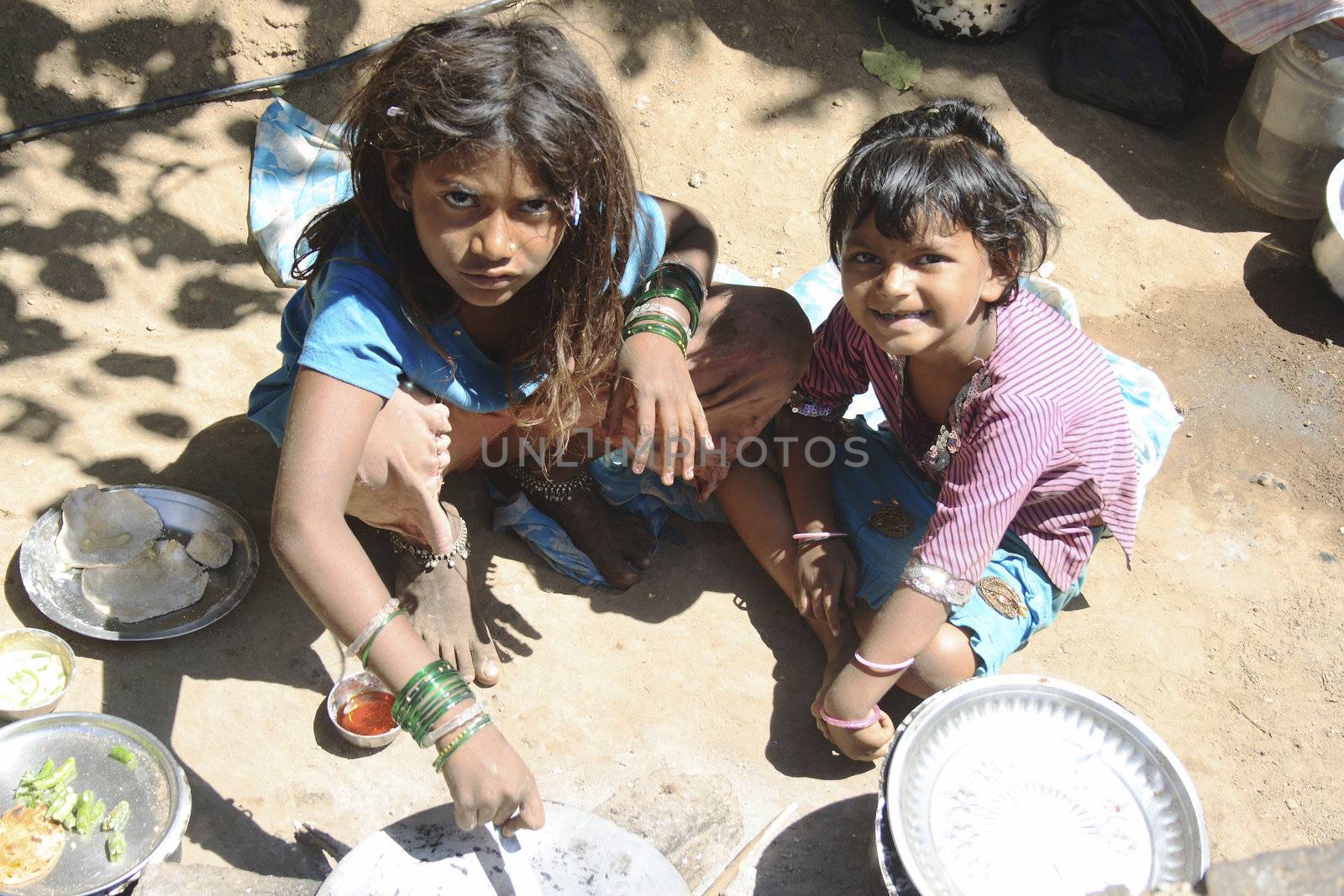February 2010, Karla Caves India, children preparing lunch by the pavement
