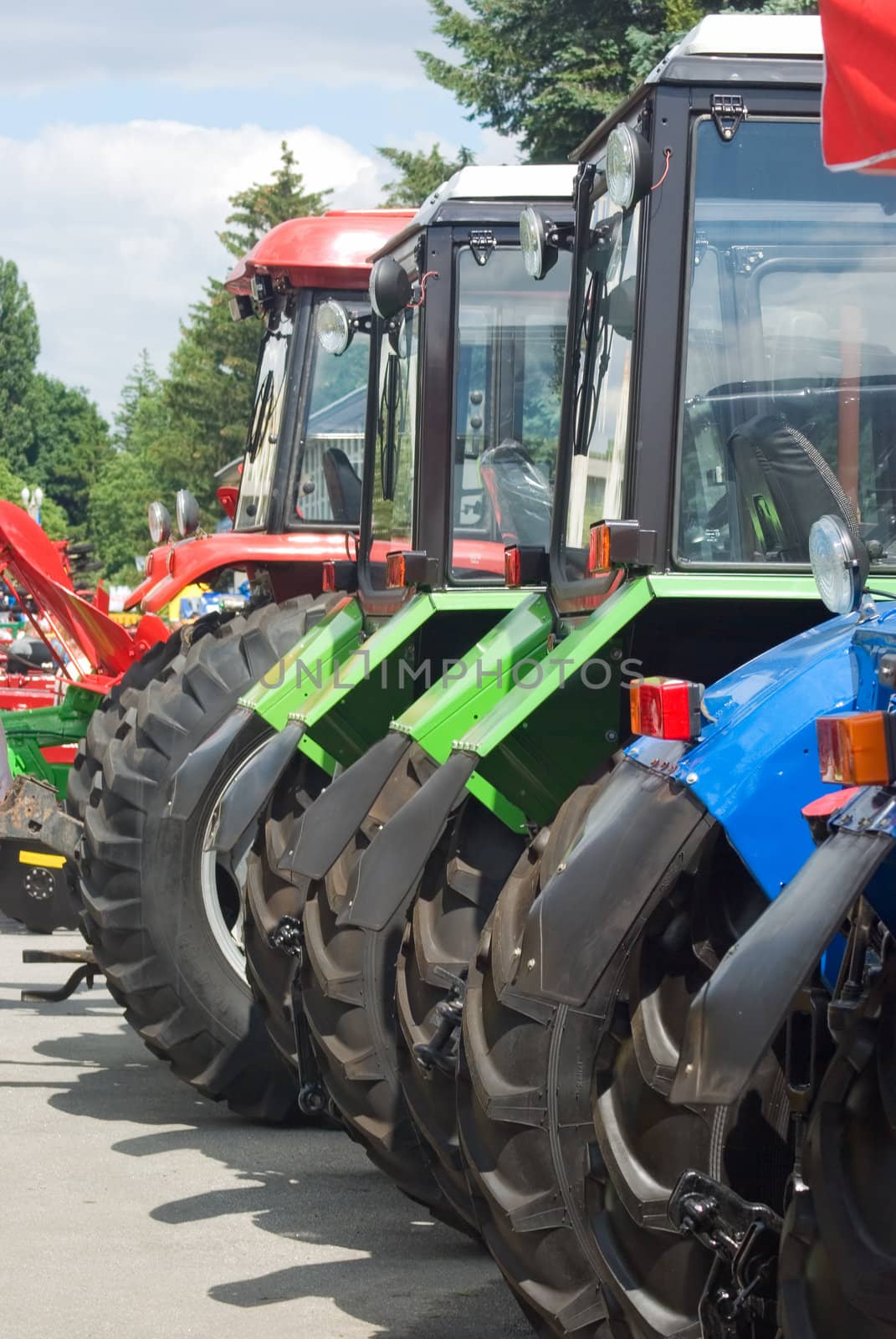 
new tractors standing in a row, ready to work