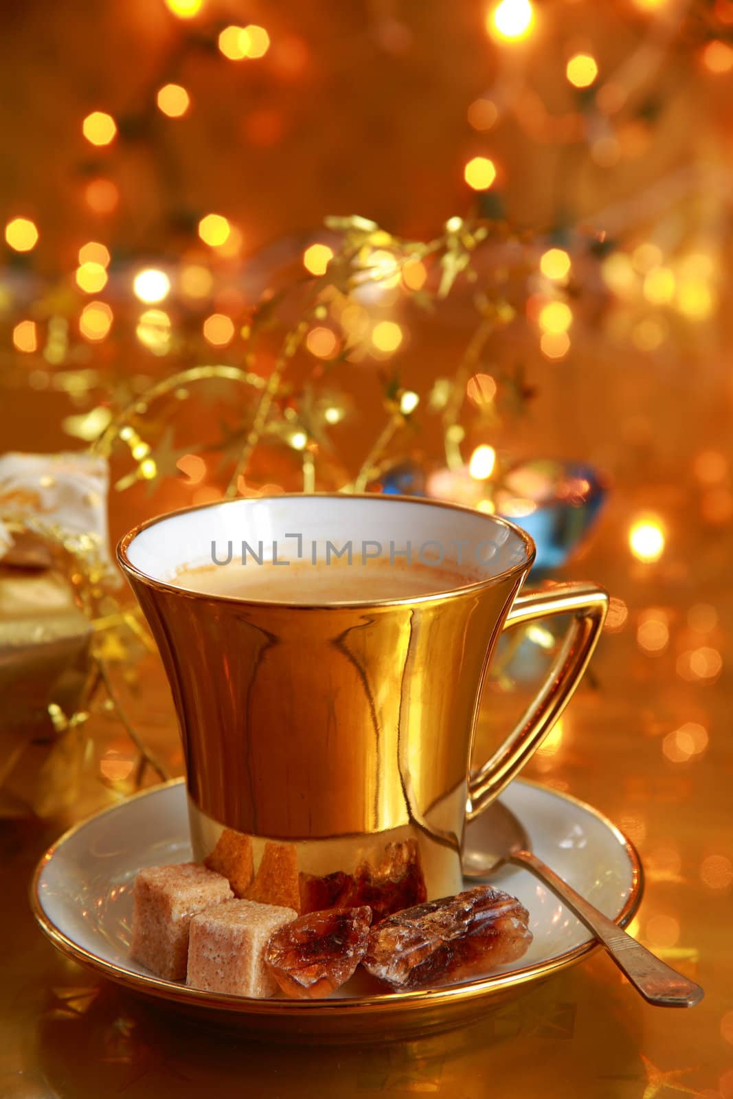 Coffee in gold cup with lights on background by andrzej_sowa