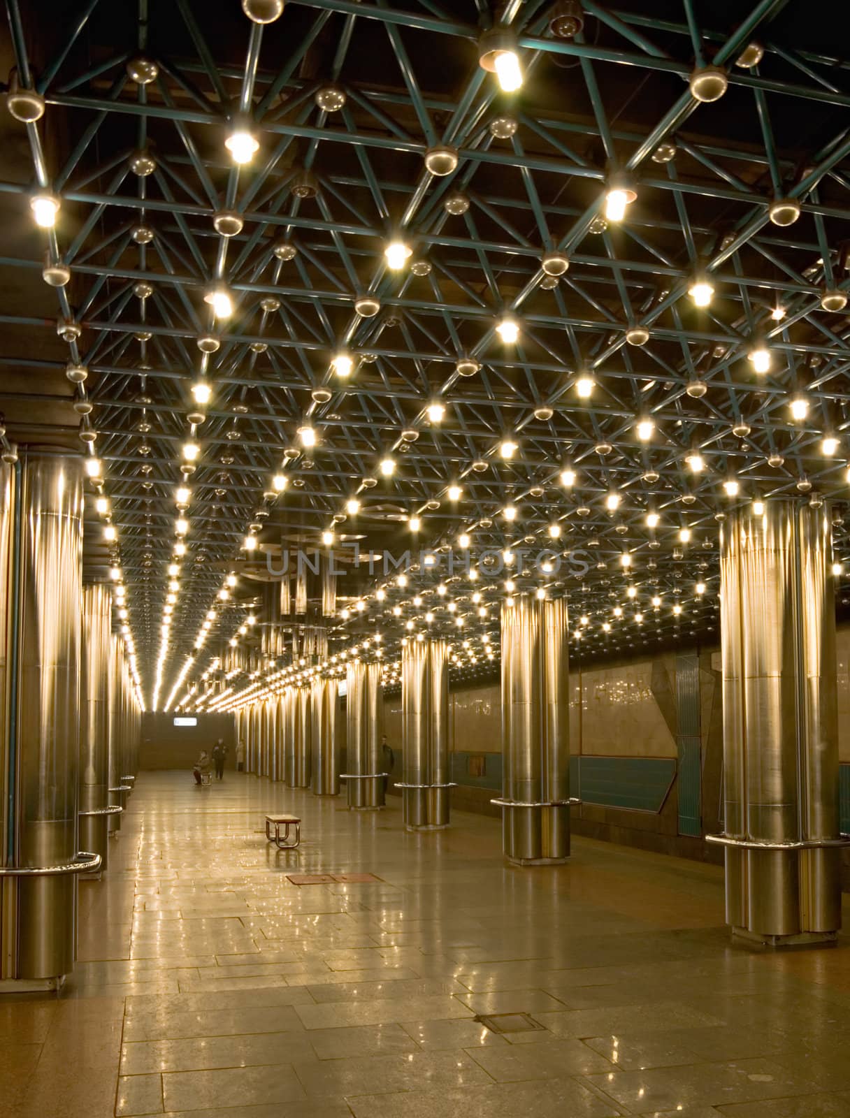 
empty subway station with shiny steel colonnade