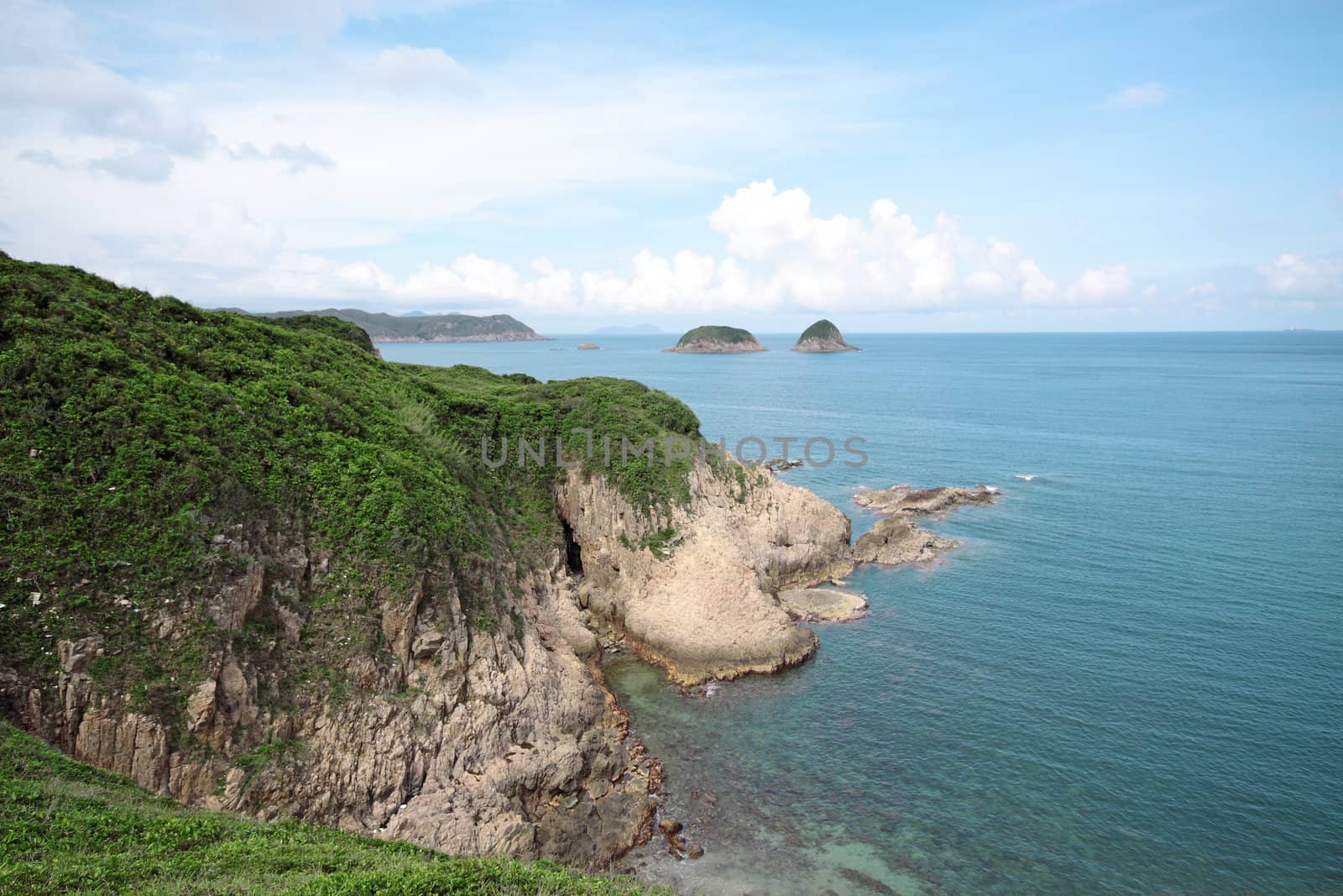 coast, blue sky and green mountain