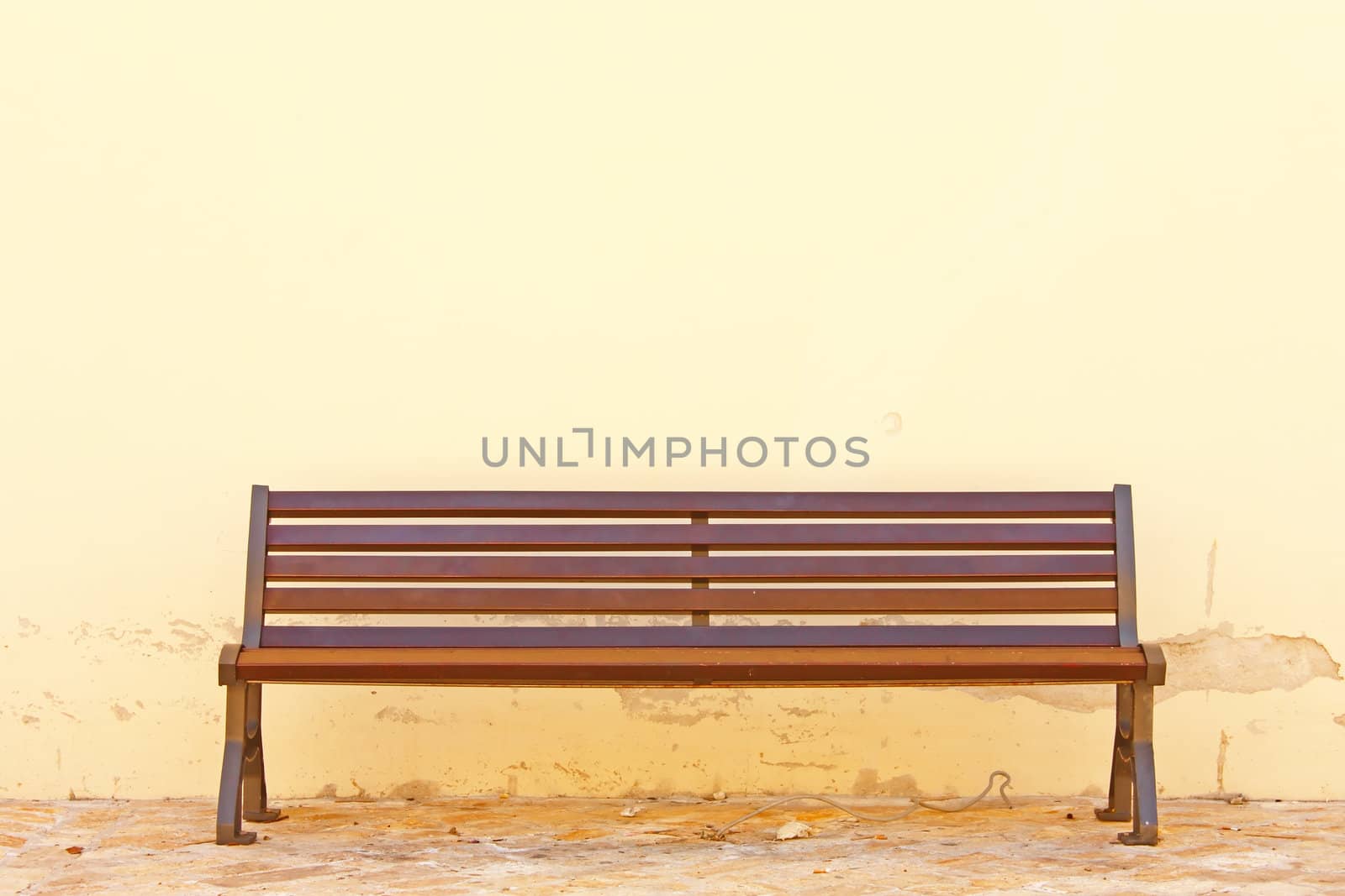 Wooden bench in front of the wall