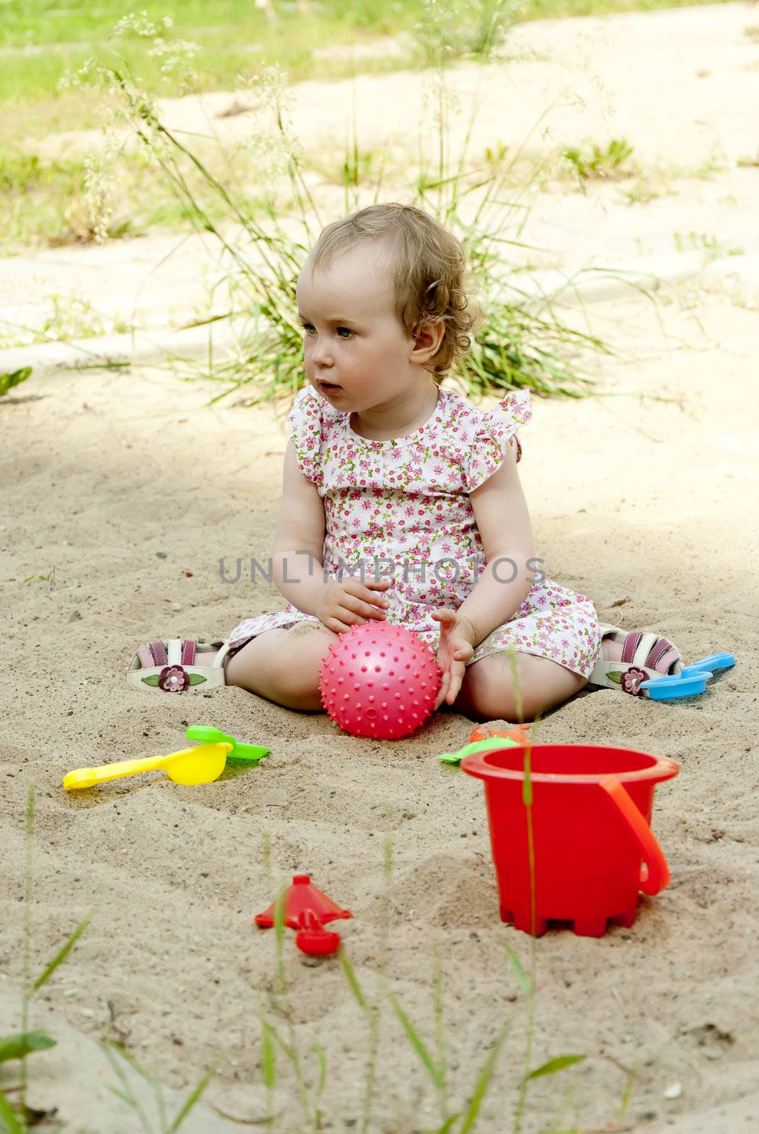 little girl playing in the sandbox