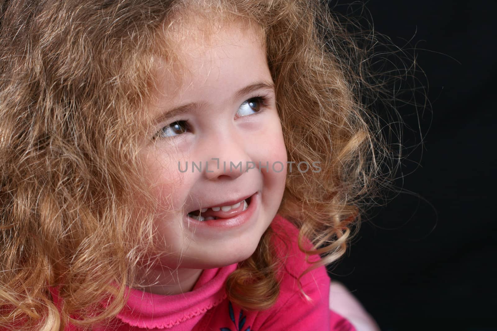 Beautiful young girl with curly hair and cute features