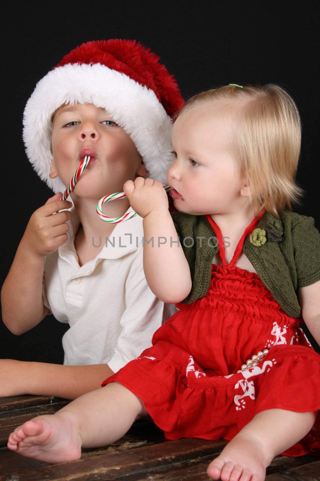 Christmas brother and sister eating Candy Canes 