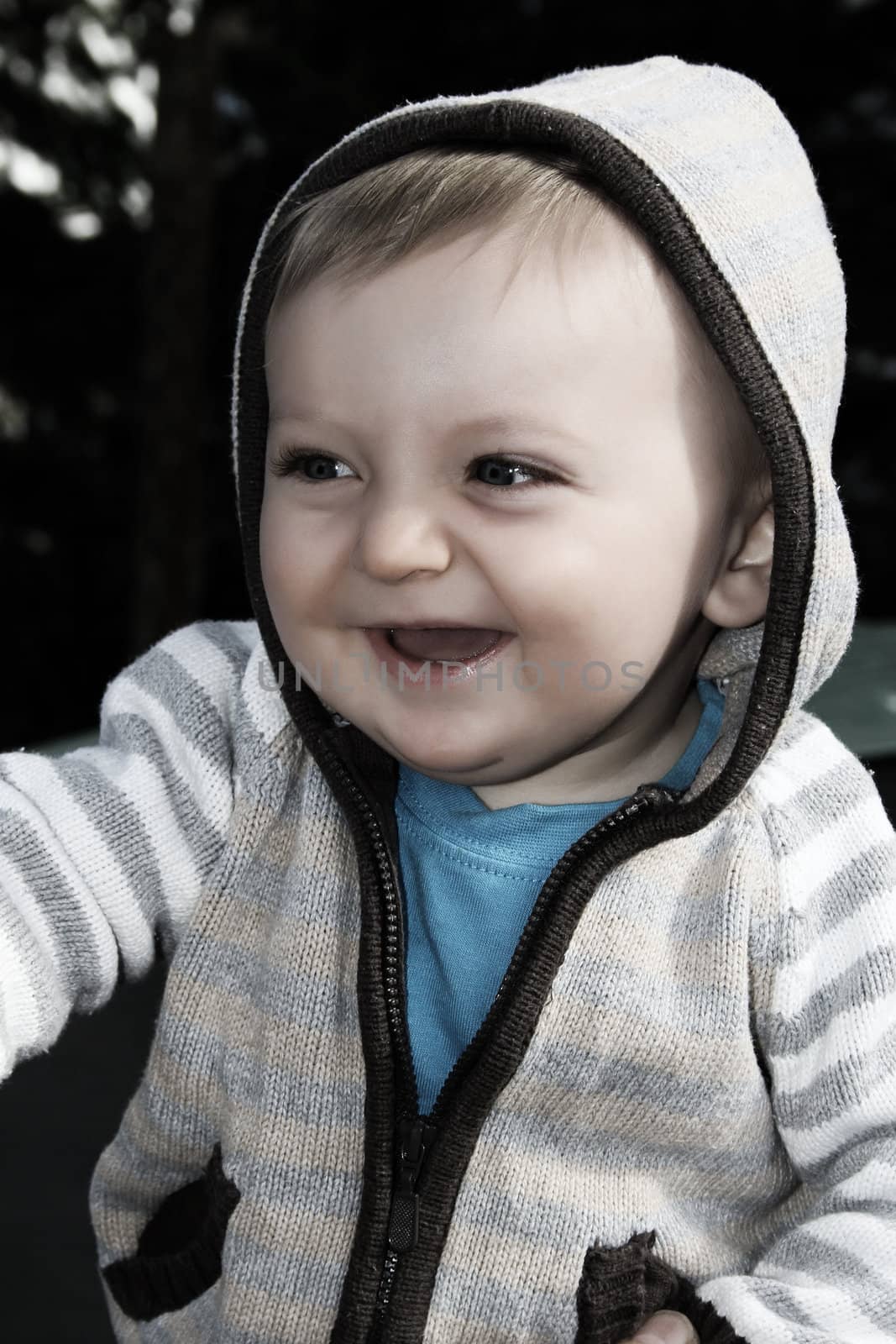 Baby boy playing outside in the garden wearing jersey