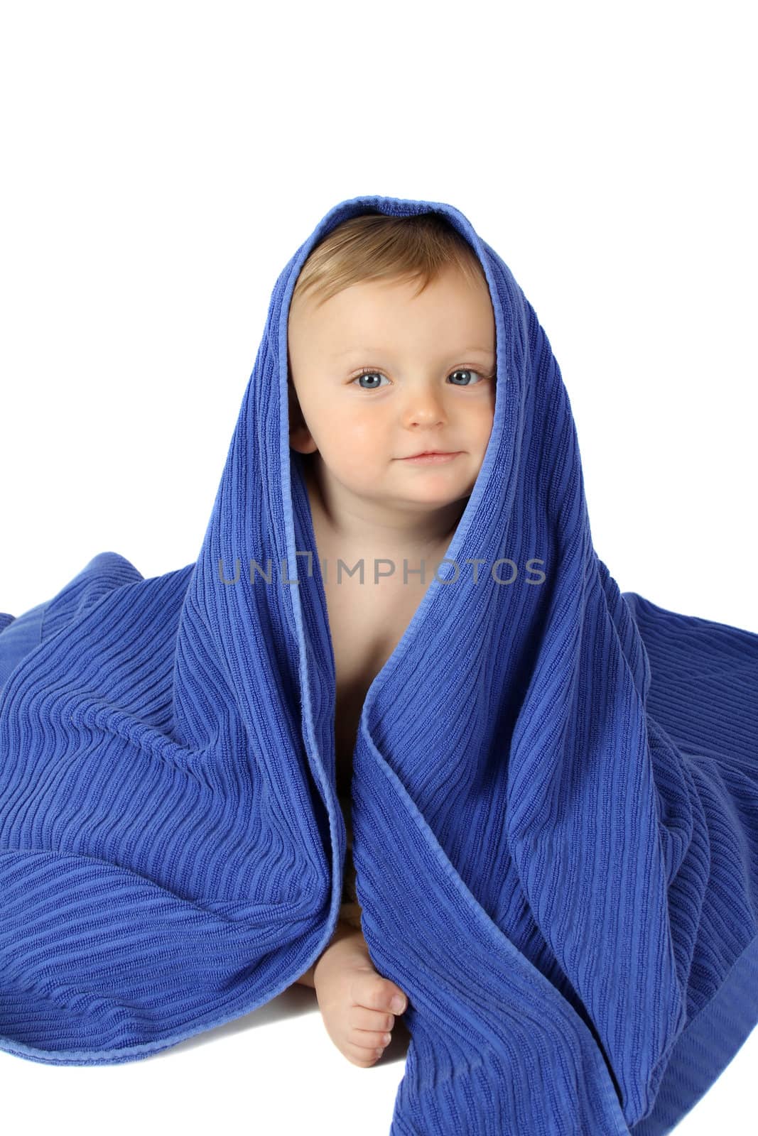 Beautiful baby boy wrapped in a soft blue towel