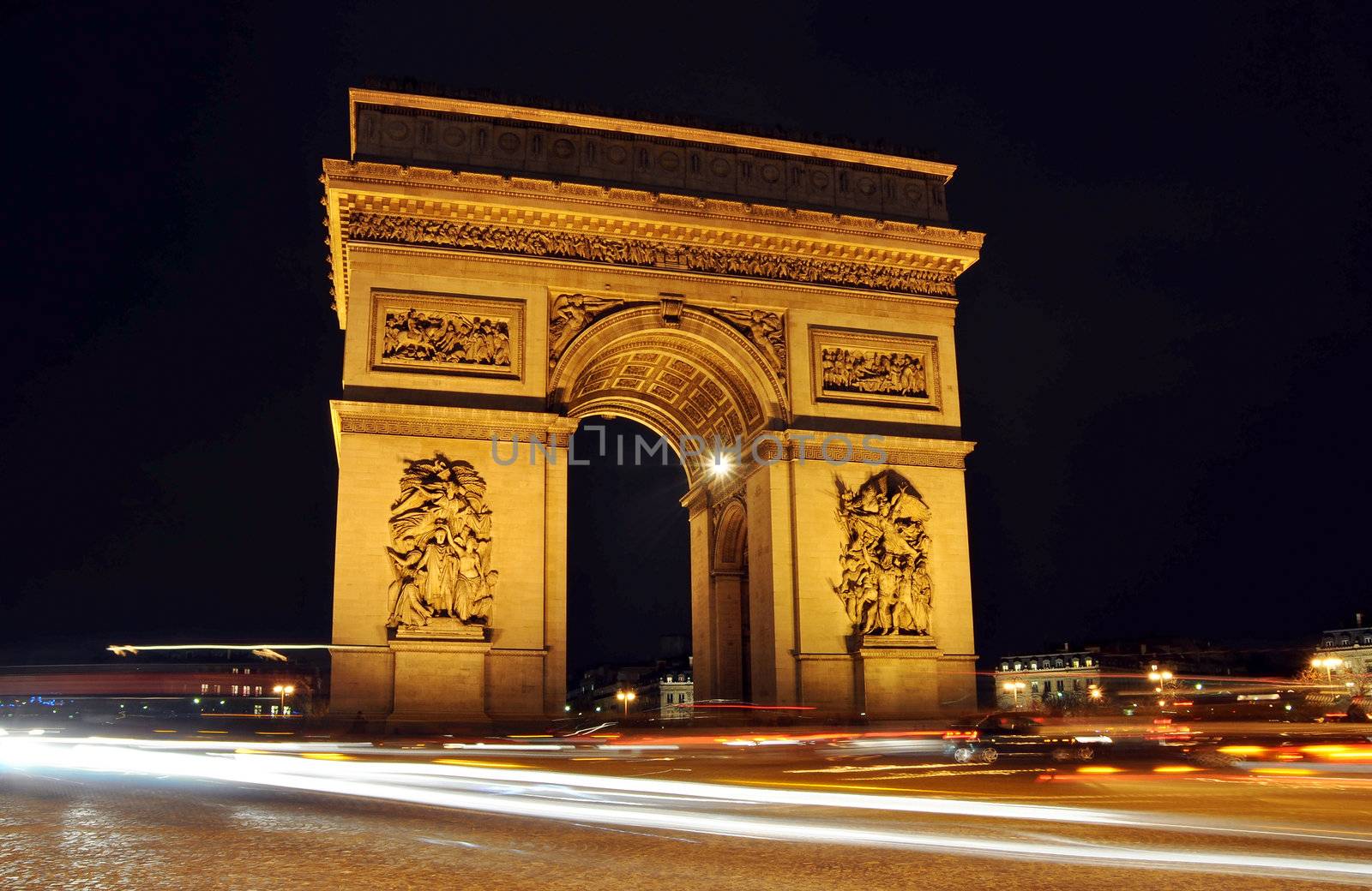 The Arc de Triomphe at night in Paris, France