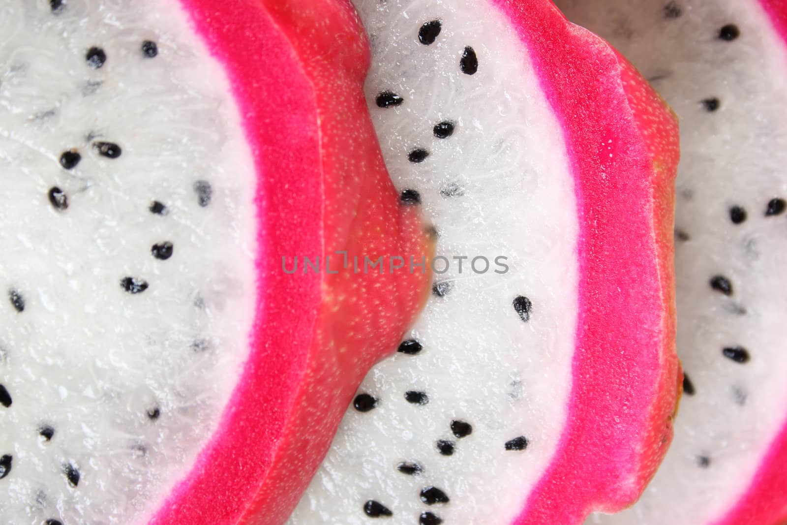 Pink pitahaya dragon fruit background sliced in pieces 