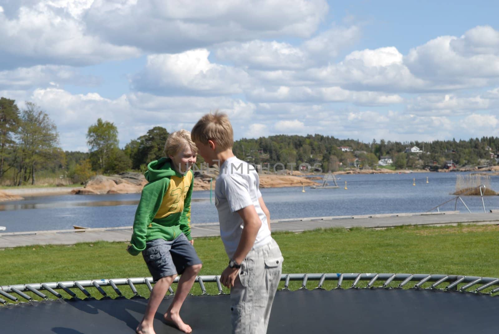 boys playing on the trampoline. Please note: No negative use allowed.